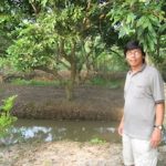 Our guide in front of garden at homestay